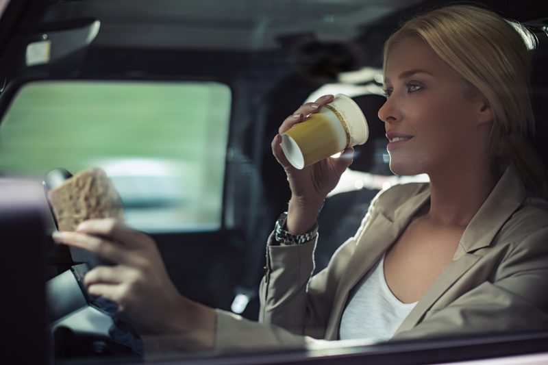 woman, car, driving, coffee, coffee cup, driving with coffee, sandwich