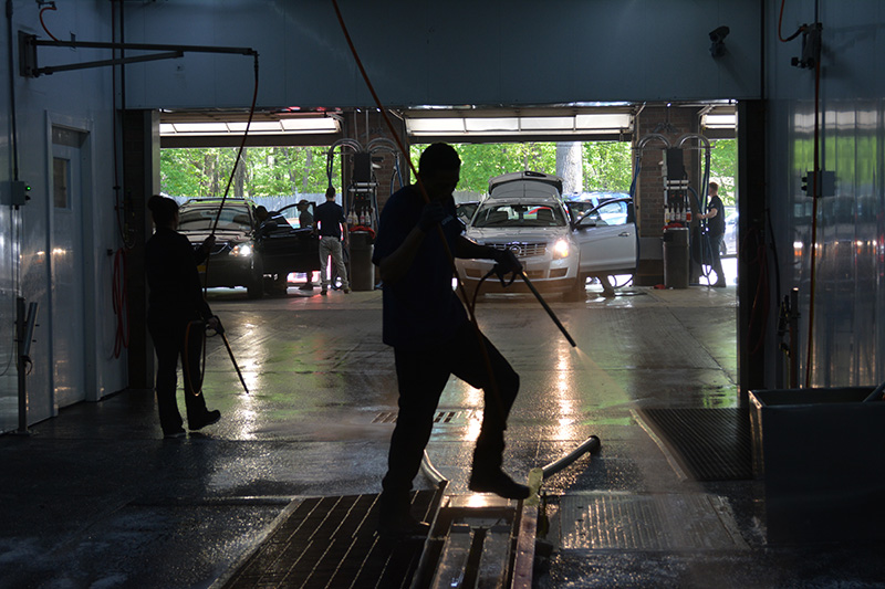 carwash tunnel, cars, car doors, hoses, employees, cleaning, hosing, detailing